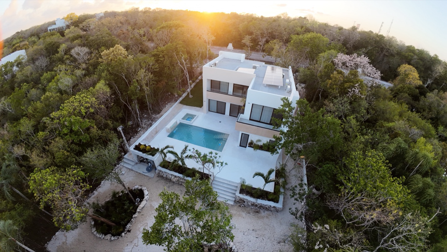 Casa Arroyo Blanco and its pool surrounded by the Akumal jungle at sunset